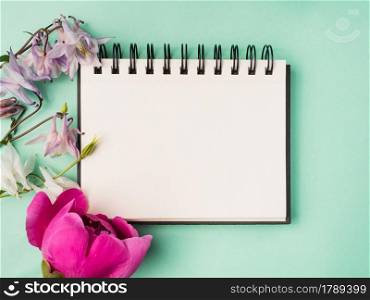 Bright flowers and a place for your congratulatory message. Closeup, view from above. No people. Concept of preparation for a holiday. Congratulations for relatives, friends and colleagues. Bright flowers and a place for your congratulatory message