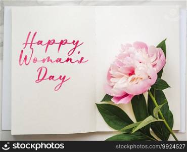 Bright flowers and Happy Women’s Day lettering. Close-up, no people, texture. Congratulations for family, relatives, friends and colleagues. Bright flowers and Happy Women’s Day lettering