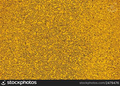 Bright golden artificial scales and glitter in small combs abstract background