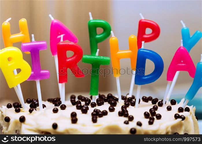 bright happy birthday candles on a birthday cake