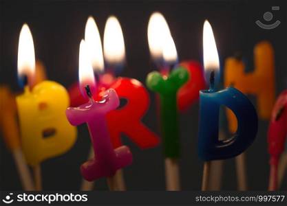 bright happy birthday candles on a birthday cake