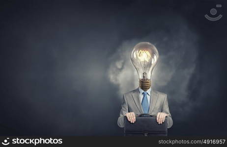 Bright head. Businessman in suit with light bulb instead of head