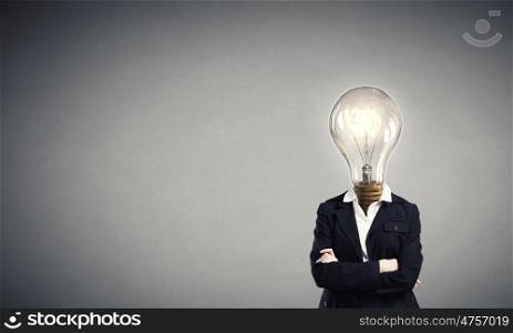 Bright head. Businesswoman in suit with light bulb instead of head