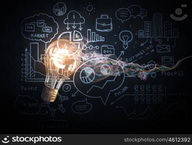 Bright idea for business growth. Glass glowing light bulb and business sketched ideas