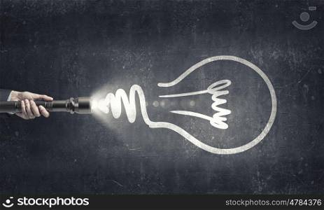 Bright idea in darkness. Close up of human hand with lantern and idea concept