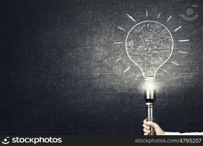 Bright idea in darkness. Close up of human hand with lantern and idea concept