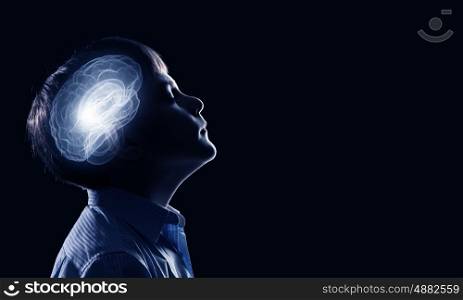 Bright idea. Young thoughtful boy of school age with closed eyes