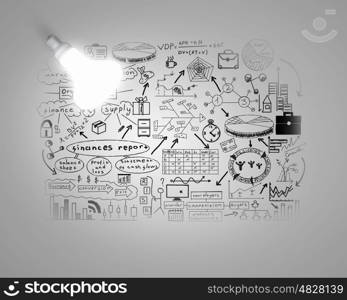 Bright ideas for business. Glowing light bulb on wall with sketches strategy plan