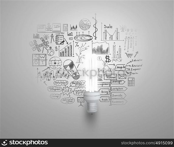 Bright ideas for business. Glowing light bulb on wall with sketches strategy plan