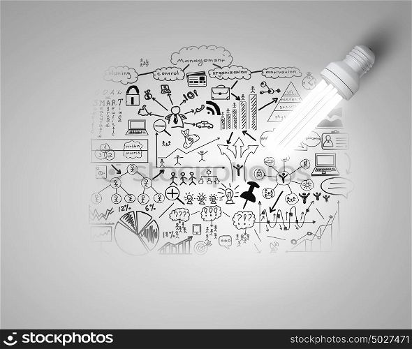 Bright ideas for business. Glowing light bulb on wall with sketches strategy plan