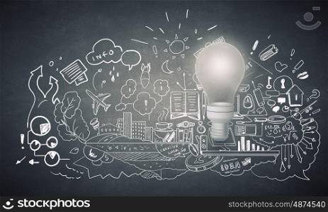 Bright ideas on wall. Glowing glass light bulb and business sketches at concrete background