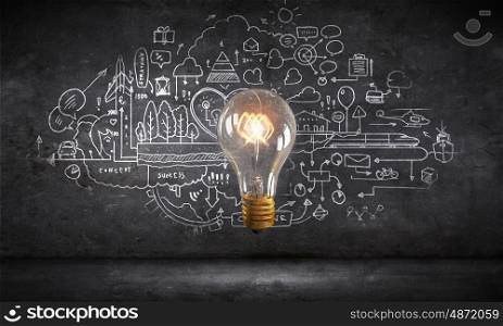 Bright ideas on wall. Glowing glass light bulb and business sketches at dark background