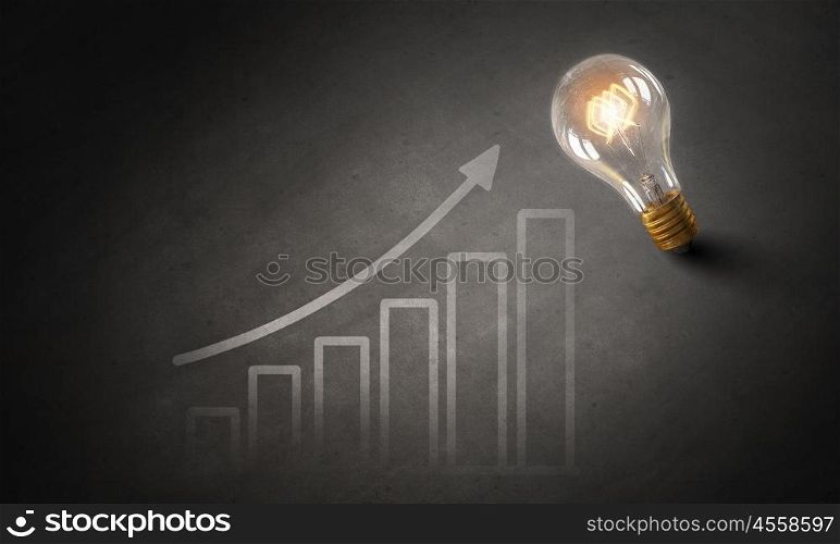 Bright ideas on wall. Glowing glass light bulb hanging from above and business sketches at dark background