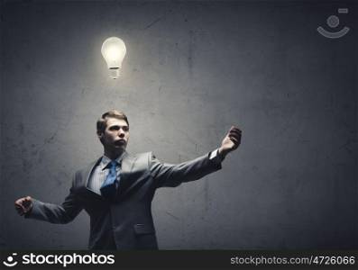 Bright ideas. Young confident businessman and light bulb above his head