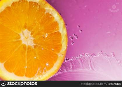 bright juicy orange and splashes on violet background