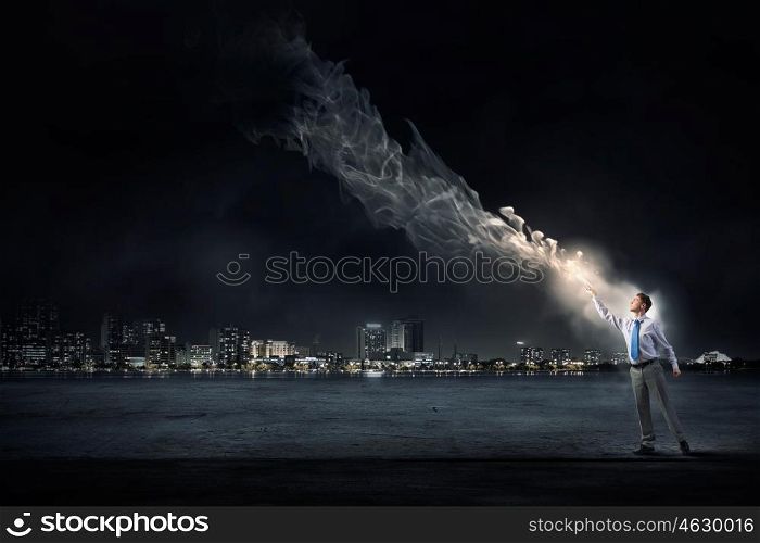 Bright light of education in darkness. Young screaming businessman reaching hand with opened book