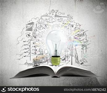 Bright light of education. Old opened book with glass bulb and business strategy sketches