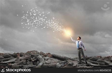 Bright light of education. Young screaming businessman on pile reaching hand with opened book