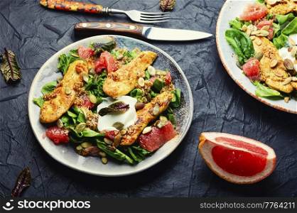 Bright meat salad with chicken, citrus fruits, lettuce and yogurt.. Spring salad of chicken breast and citrus fruits.