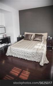 Bright, modern bedroom with beige bedspread.