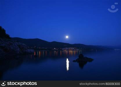 bright moon illuminates sea shore. Night on resort