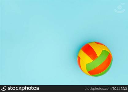 Bright multi-colored volleyball ball on blue background with copy space. Top view Flat lay Minimal style Template for card, design.. Bright multi-colored volleyball ball on blue background with copy space. Top view Flat lay Minimal style Template for card, design