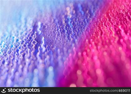 Bright multicolored abstract background. Drops on a shiny surface with a motion blur effect. Violet tonality in the style of the 80-90s.. Drops on a shiny surface with a motion blur effect. Violet tonality in the style of the 80-90s.