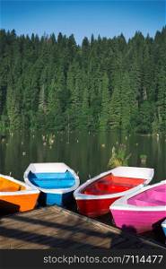 bright multicolored boats on a mountain lake