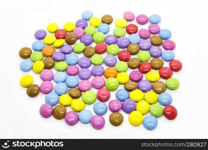 Bright multicolored glazed chocolate candies isolated on a white background