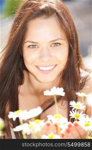 bright outdoor picture of beautiful woman with flowers