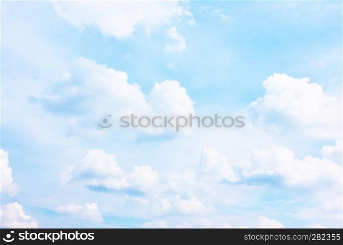Bright pastel blue sky with white clouds - background and space for your own text