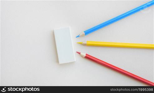 bright pencils lying near rubber