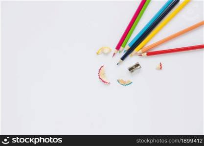 bright pencils near sharpener shaving. Resolution and high quality beautiful photo. bright pencils near sharpener shaving. High quality beautiful photo concept