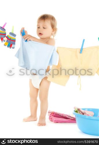 bright picture of adorable baby doing laundry .