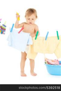 bright picture of adorable baby doing laundry .