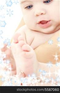 bright picture of adorable baby in mother hands with snowflakes