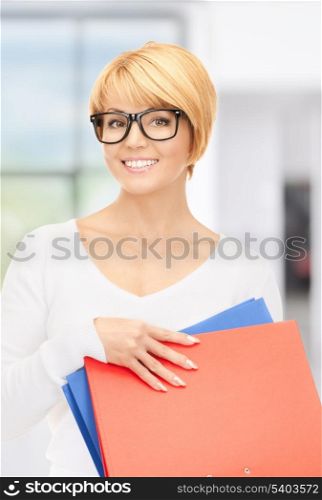 bright picture of attractive businesswoman with folders