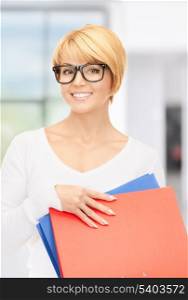 bright picture of attractive businesswoman with folders
