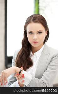 bright picture of attractive businesswoman with watch..