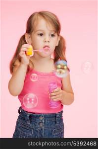 bright picture of beautiful litle girl with soap bubbles