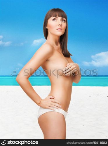 bright picture of beautiful topless woman on the beach