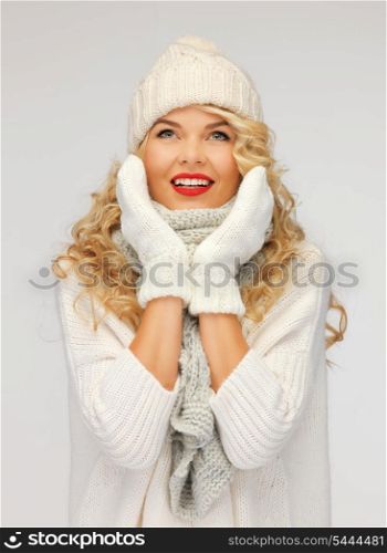 bright picture of beautiful woman in hat, muffler and mittens..