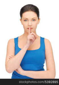 bright picture of beautiful woman making a hush gesture