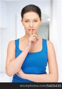 bright picture of beautiful woman making a hush gesture