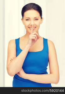 bright picture of beautiful woman making a hush gesture. woman making a hush gesture