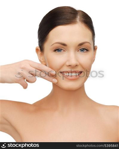 bright picture of beautiful woman pointing to cheek.