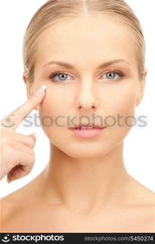 bright picture of beautiful woman pointing to cheek.