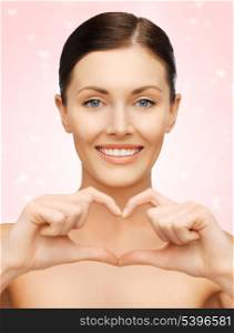 bright picture of beautiful woman showing heart shape