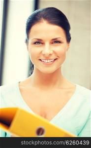 bright picture of beautiful woman with folder. woman with folder