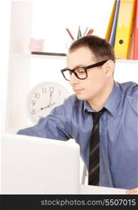 bright picture of businessman with laptop computer in office